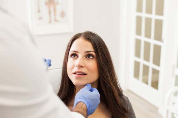 Mujer recibiendo una consulta con un dermatólogo