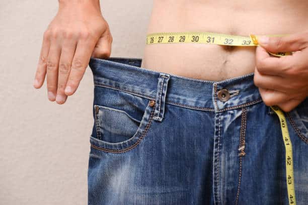Men wearing big jeans after diet.